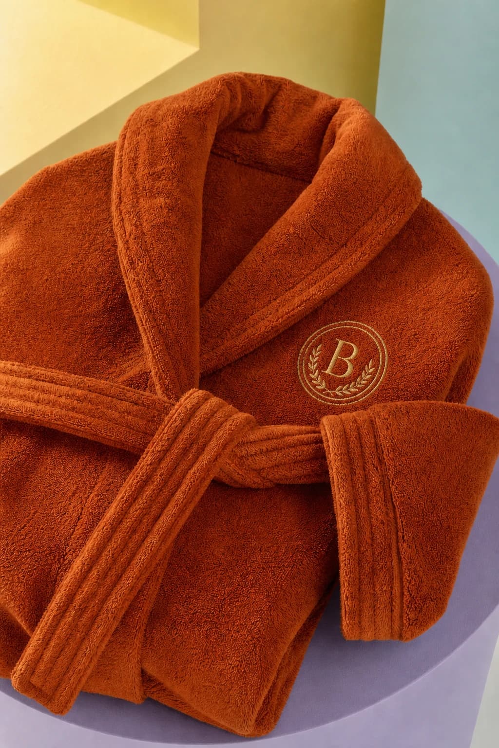 Escalation Orange terry robe detail showing collar, belt, and textured pile.
