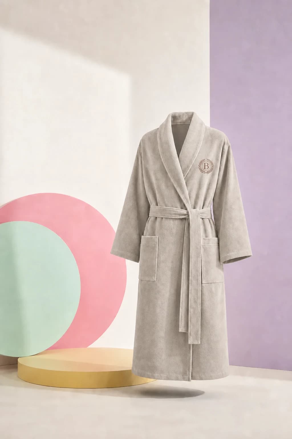 A woman in the blue Quarterly Wrap presents beside oversized mint, pink, and lilac chart discs.